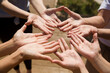 © ulza - People with united hands on the team top view