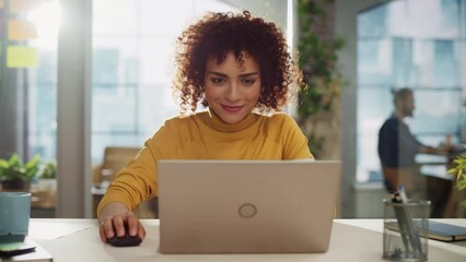 Leinwandbilder - Close Up Portrait of a Happy Middle Eastern Female Sitting at a Desk in Creative Agency. Young Stylish Female with Curly Hair Using Laptop Computer in Marketing Agency. Static Shot.