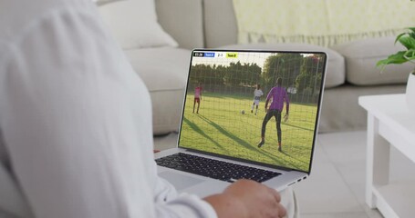 Poster - Hands using laptop with diverse male soccer players playing match on screen