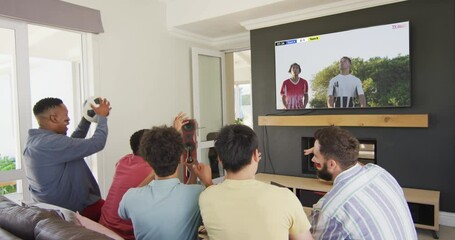 Canvas Print - Diverse friends supporting and watching tv with diverse male soccer players playing match on screen