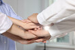 © New Africa - Group of people holding hands together indoors, closeup. Unity concept