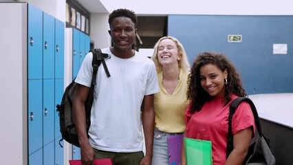 Multiracial group portrait of high school students smiling at camera. Diverse young teenage people standing together at college hall. High quality 4k footage