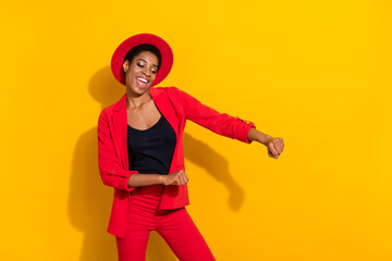 Photo of cute funky short hair person dressed red suit cap smiling dancing isolated yellow color background