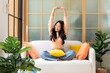 © freebird7977 - Young smiling women chill & relax raise arm after working and meeting at home.  Lifestyle freelance happy and drinking coffee in luxury living room in vacation holiday and summer day.