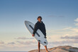 © Yakobchuk Olena - Full length view of the man carrying surfboard at the beach against clear sky
