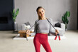 Fitness Woman skipping with jump rope at home.