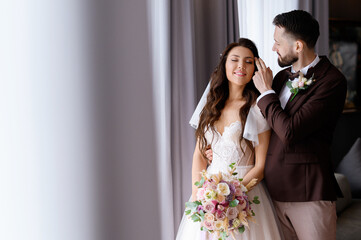 Married couple falling in love indoors before wedding ceremony