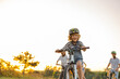© pikselstock - Happy family cycling together in the countryside