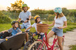 © pikselstock - Happy family cycling together in the countryside