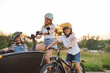 © pikselstock - Mother with children cycling in the countryside