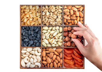 Wall Mural - Hand with assorted nuts and dried fruit collection. Different superfoods. Vegetarian snack of different nuts. organic mixed nuts background