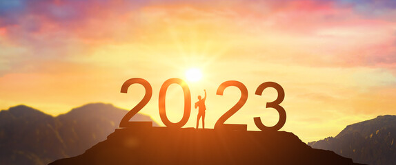 2023. Welcome Happy new year 2023. Man meets dawn in mountains. happy New Year 2023. New Start motivation inspirational quote message on silhouette of winner woman