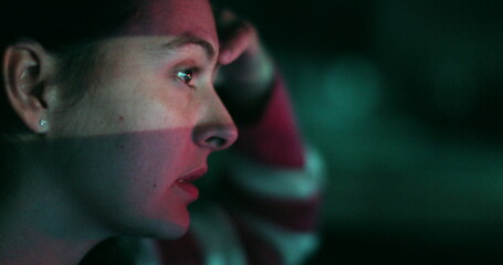 Wall Mural - Pensive woman driving at night in city. Thoughtful female driver face in evening