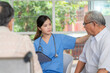 © bung - Young female nurse doctor caregiver holding tablet explaining prescription prescribing drug to elderly patient at nursing home. Record check up information. Healthcare pharmacy and insurance service