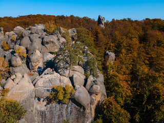 Wall Mural - couple traveler sitting on the top of the rock with beautiful landscape of autumn forest