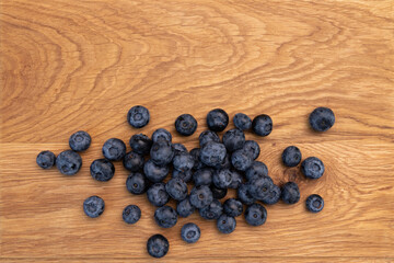 Wall Mural - heap of ripe blueberries on wooden background