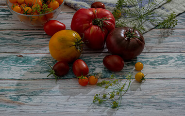 Fresh tomatoes on a wooden kitchen table in a rustic house.