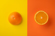 Sliced ​​ripe orange on bright abstract background. Flat composition.