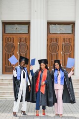 Wall Mural - portrait of multiracial graduates holding diploma