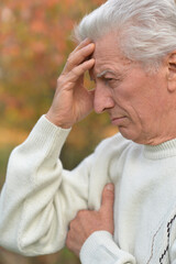 Poster - Close up portrait of older man in autumn park 