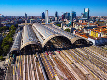 Aerial View Of The Station Where Trains Arrive. An Old Arched Structure Made Of Metal And Glass Above The Station Poles. Tourism. Transport. Skyline With Tall Buildings. Italy, Milan, 09.2022