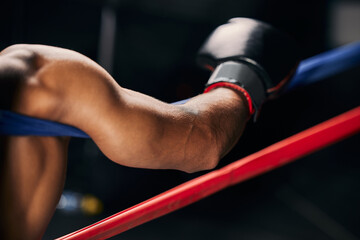 Sticker - Sports, fight and hand of a boxing man resting in the corner of a boxing ring during an exhibition match, exercise or workout. Motivation, fitness and training boxer relax and tired after fighting