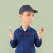 Funny car mechanic with big head and different tools on color background