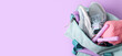 © Pixel-Shot - Bag with sportswear and equipment on lilac background with space for text