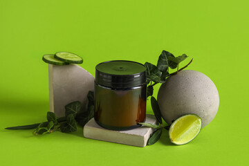 Composition with jar of natural cosmetic product and plaster decor on color background