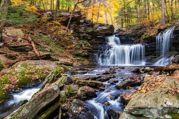 tranquil landscape of silky cascading water  against vibrant autumn forest background in Pennsylvania 