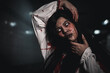 © sorapop - Screaming zombie female face with blood grabs her head to twist it off, Horror bloodthirsty woman ghost or zombie she is horror scary with breaks her neck at dark night, Happy halloween day concept