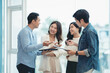 © amnaj - Group of young Asian businesspeople brainstorming meeting to discuss planning strategies new business development working on a new startup project in the office.