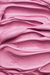 Bright pink icing frosting close up texture