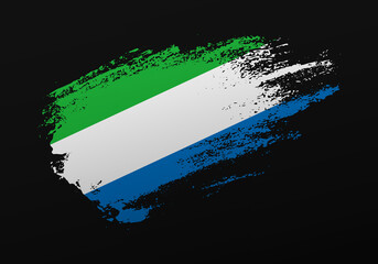 Abstract creative patriotic hand painted stain brush flag of Sierra Leone on black background