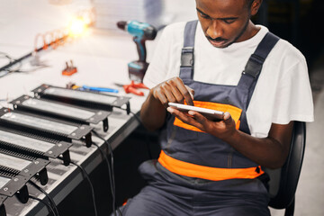 Wall Mural - african factory worker using tablet