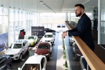 Wall Mural - businessman chooses a new executive class car in a dealer showroom, Concept car leasing