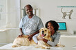 © AnnaStills - Portrait of African vet doctor and nurse caring about animals at vet clinic
