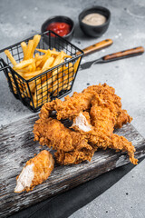 Wall Mural - Breaded chicken strips with french fries and ketchup. Gray backgrund. Top view