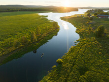 Aerial View Of A Canoe Sailing The Torne River At Sunset In Overtornea, Norrbotten, Sweden.