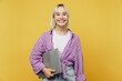 © ViDi Studio - Young smiling happy programmer blonde IT woman 20s she wears pink tied shirt white t-shirt hold closed laptop pc computer isolated on plain yellow background studio portrait. People lifestyle concept.