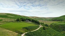 Aerial Footage Of Yorkshire Countryside Valleys Moorland And Moving Slowly Up A Footpath Towards A Farmhouse. Shot At Marsden Village Huddersfield, West Yorkshire.