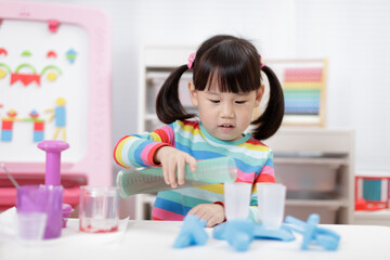 Wall Mural - young girl pretend playing food preparing at home