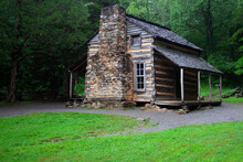 Old Log Cabin In The Forest On A Wet Rainy Day.