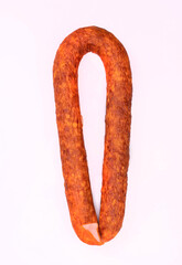 Wall Mural - Traditional smoked pork sausage, long, isolated. Polish meat sausage, a packshot photo for package design.