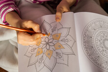 Woman Coloring Antistress Page. Female Hand Painting Mandala. Female Painting Mandalas To Combat Stress. Relaxing Hobby Mental Wellbeing And Art Therapy. Woman Paints Sketch, Meditative Process Of