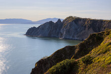 View Of The Rocky Cape And Mountains. Beautiful Landscape. Natural Landmark Of The Magadan Region. Journey To The Far East Of Russia. Cape Nyuklya, Coast Of The Sea Of Okhotsk, Magadan Region, Russia.