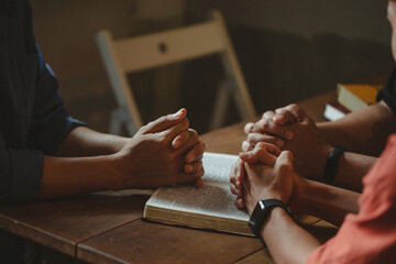 Christian group are praying to god with the bible and sharing the gospel. Concept of faith for god.