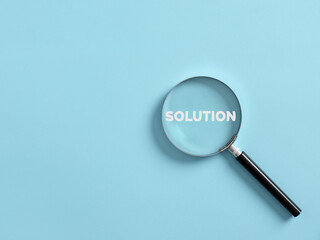 Wall Mural - Magnifier focuses on the word solution. Searching for a business solution concept.