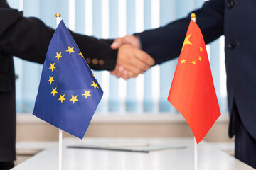 Wall Mural - Political flags of European Union and china on table. concept of negotiations, collaboration and cooperation of countries. agreement between governments.