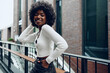 © fotofabrika - African young woman standing on city street outdoors